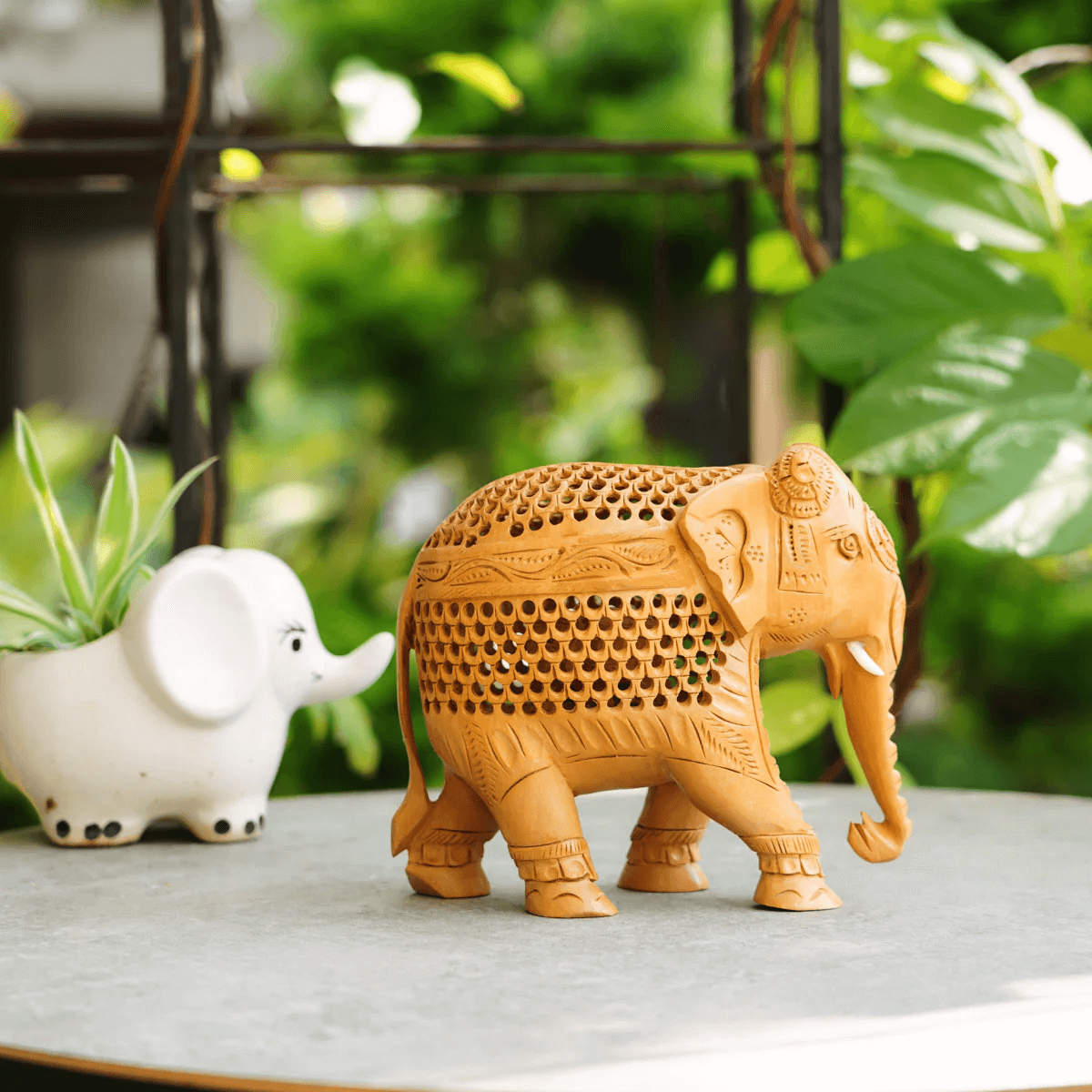 Finely carved wooden elephant figurine with jali latticework